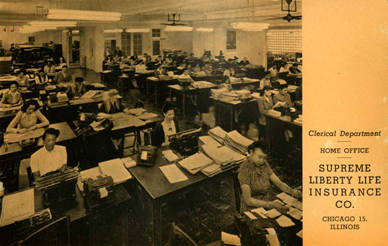 Black and white photograph of women working at desks with typewriters and stacks of paper. On the right is a white column with the text "Clerical Department/ Home Office/ Supreme Liberty Life Insurance Co./ Chicago 15, Illinois.