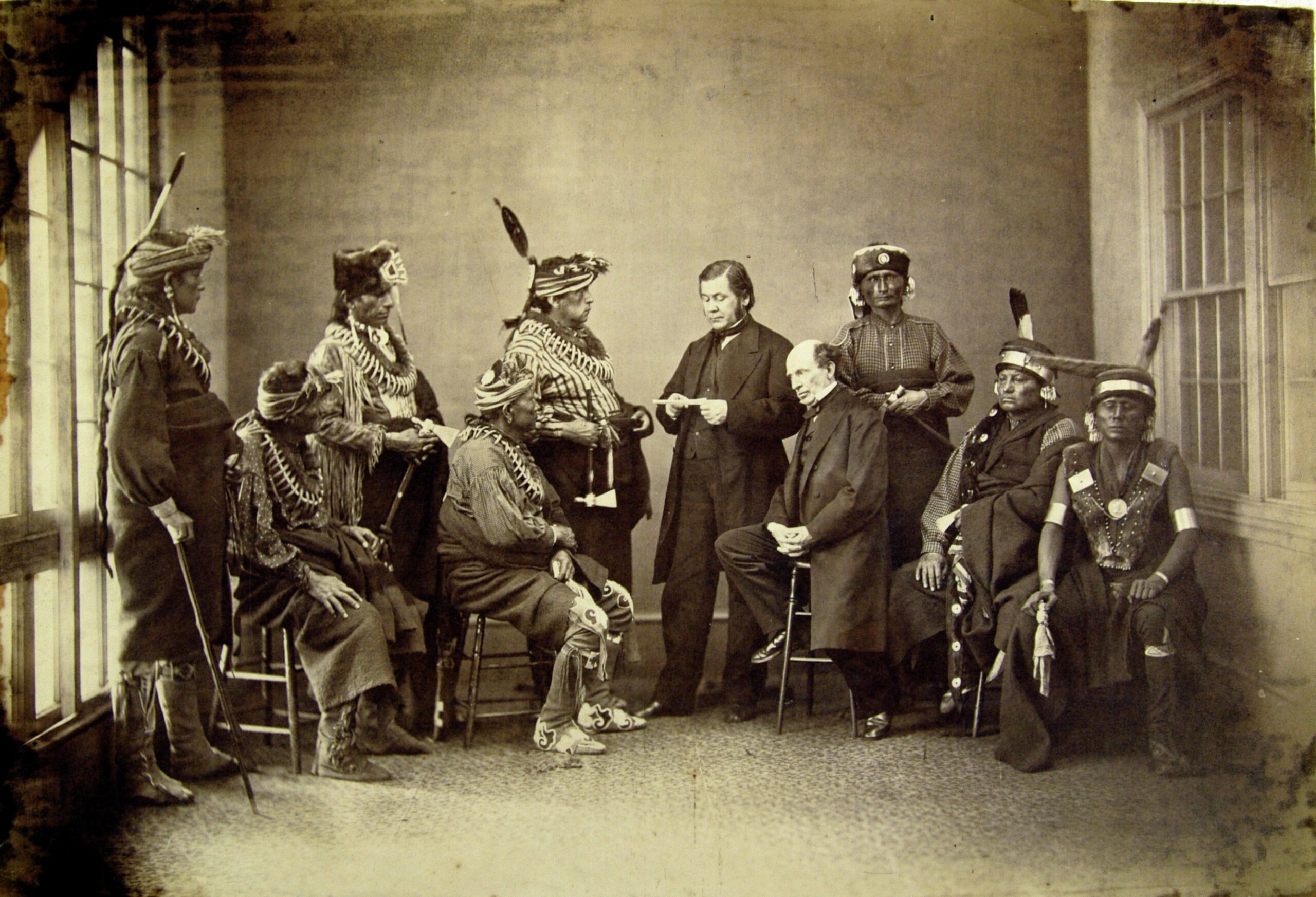 Black-and-white photograph of a group of Indigenous leaders. Some wear traditional dress and some where Euro-American suits.