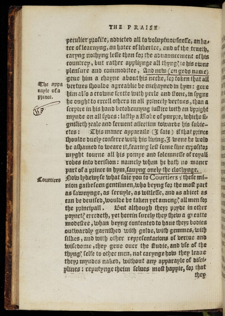Left-hand page of a bound and printed book. Text is in a Gothic font, in antiquated English. Near the top of the left-hand margin is the phrase "The apperal of a Prince" with a stylized finger pointing to the text. Near the bottom in the margin is the word "Courtiers." Two short phrases in the text are underlined.