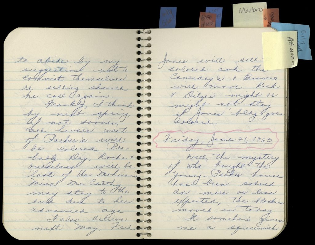 Two-page spread of small spiralbound notebook with blue cursive writing the entries on this page describe the author's fear about African Americans integrating her neighborhood.