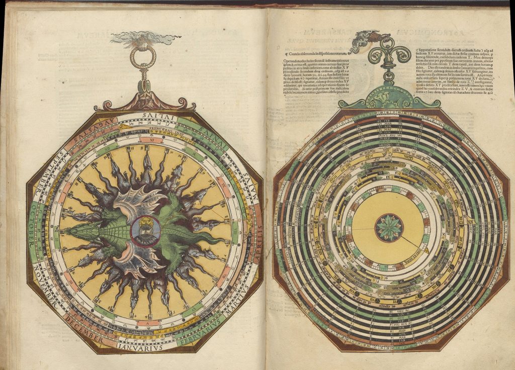 Two-page spread of two lavishly decorated stacks of rotating dials. The outermost circle of the dials on the right-hand page has the months of the year. Within it are multiple concentric smaller dials, and the edges of each are divided into many categories. The center of the innermost dial is decorated with a circle of dragon heads and tails. On the left-hand pages is another stack of concentric dials each with a series of divisions and charts on its edges.
