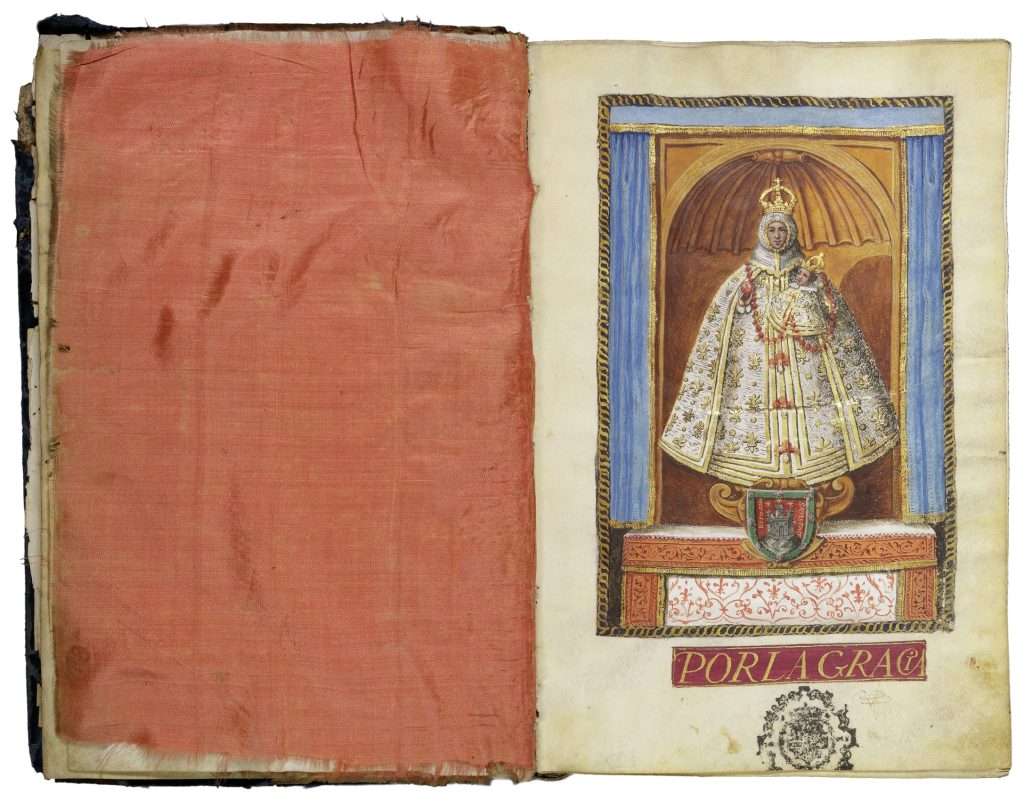 Manuscript book open in a two-page spread. On the right is a full-page illumination of the Virgin Mary holding the infant Jesus. Both are white. They wear white robes with gold decoration and golden crowns and stand in decorative alcove. The left-hand page is fully covered with a piece of red-orange silk.