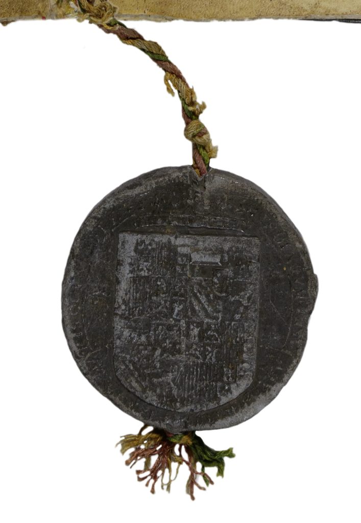 Detail image of a black seal attached to a red, green, and yellow twisted cord. A coat of arms is imprinted on the seal though the details are faded.