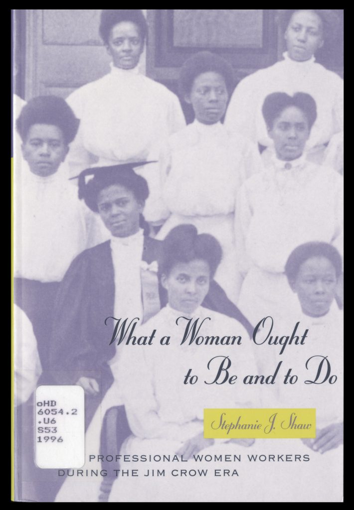 Front cover of a book. The cover is a black-and-white illustration tinted blue of four rows of Black women wearing Victorian dresses and posing for a photograph. One wears graduation robes and a mortarboard.