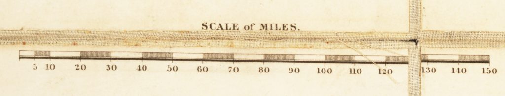 Detail of a map showing its scale of miles. Dissection folds form a cross on the right-hand side of the image.