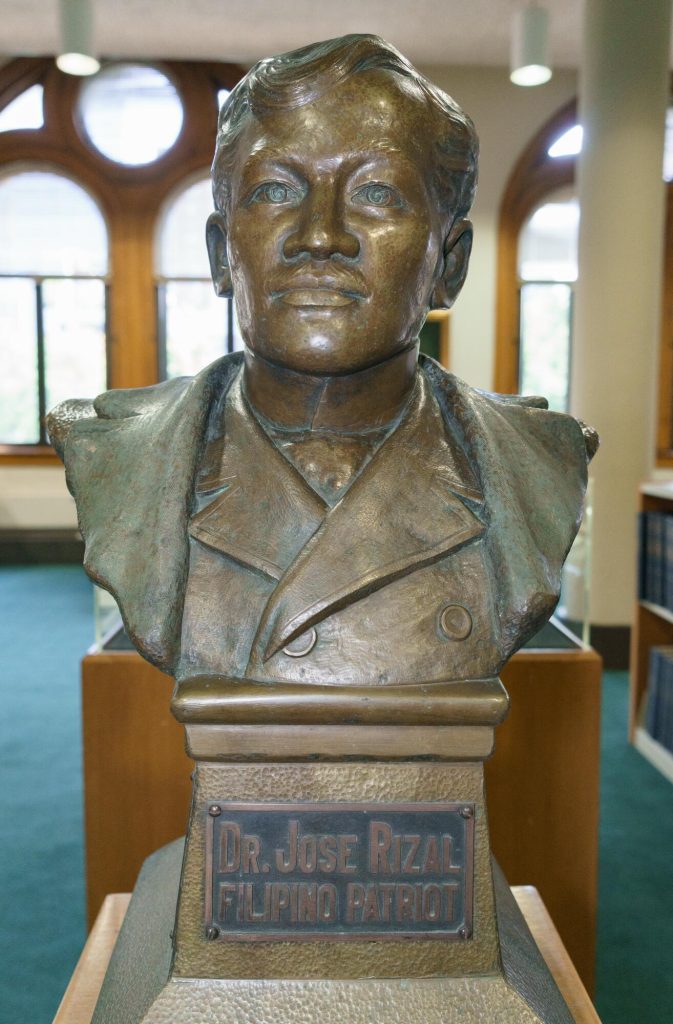 Bronze bust of a middle-aged Filipino man with a mustache. Text below the bust reads, "Dr. Jose Rizal, Filipino Patriot"