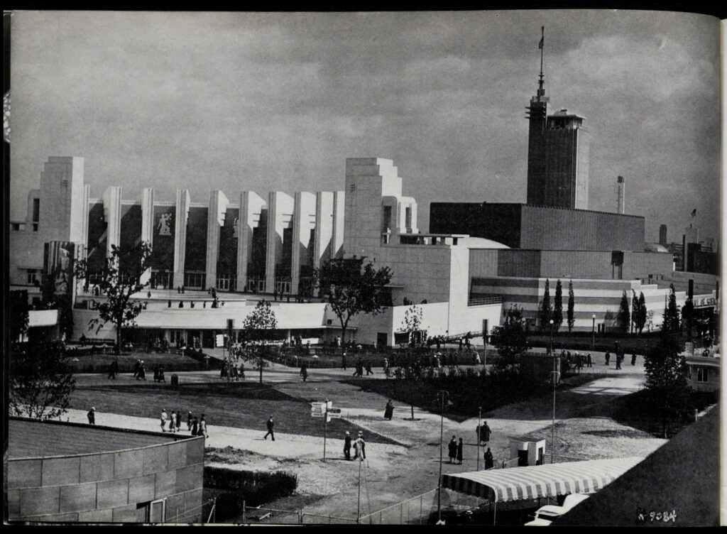 Black-and-white photo of the Hall of Science at the Century of Progress. It is a large multi-story Art Deco building in white stone with a plaza out front,