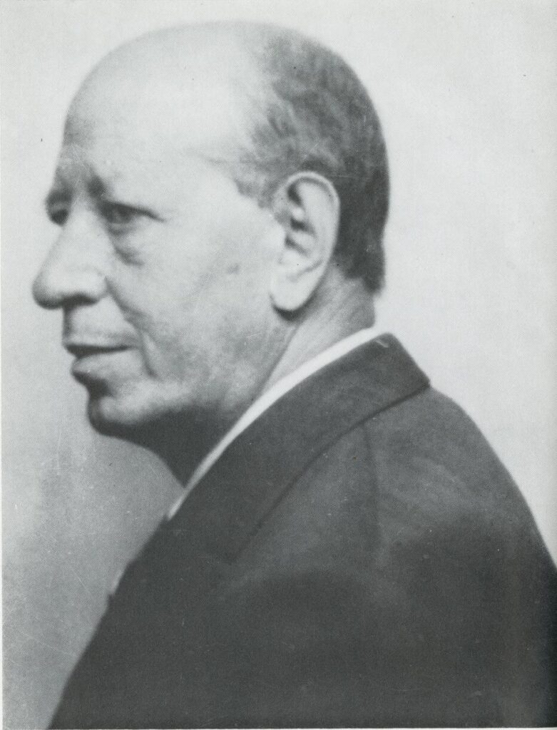 Black-and-white profile portrait of Bisno, a middle-aged balding white man wearing a suit and tie.