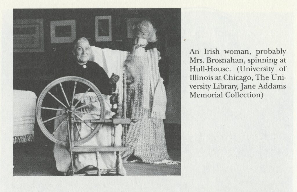 Black-and-white photograph of an elderly white woman working at a spinning wheel.
