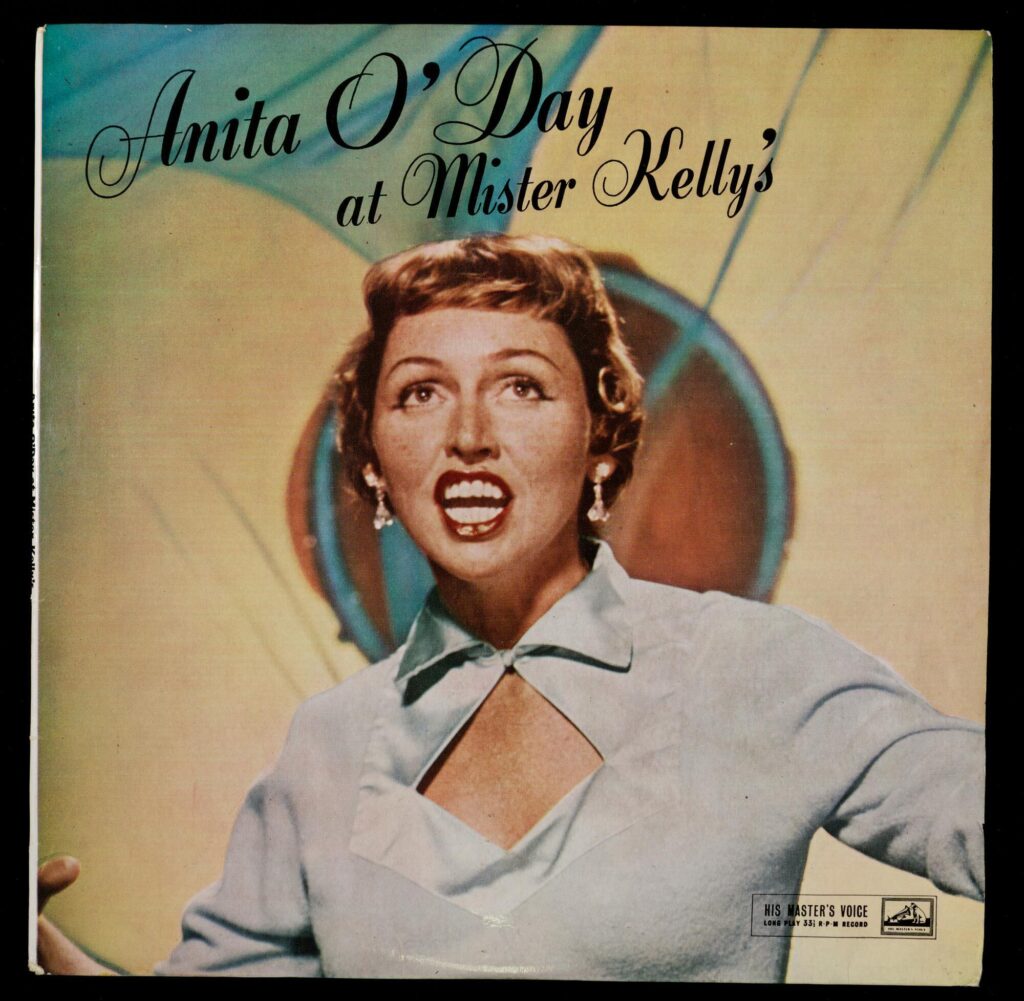Color album cover showing Anita O'Day, a white woman in a blue top, while singing.